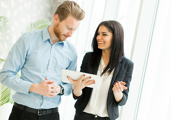 Business man and woman looking at a tablet