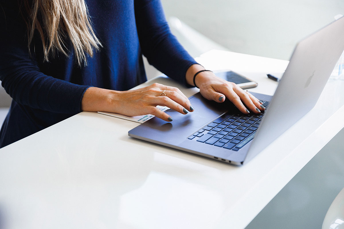 Woman typing on a laptop