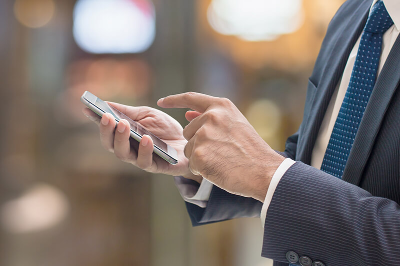 Business man browsing on cell phone