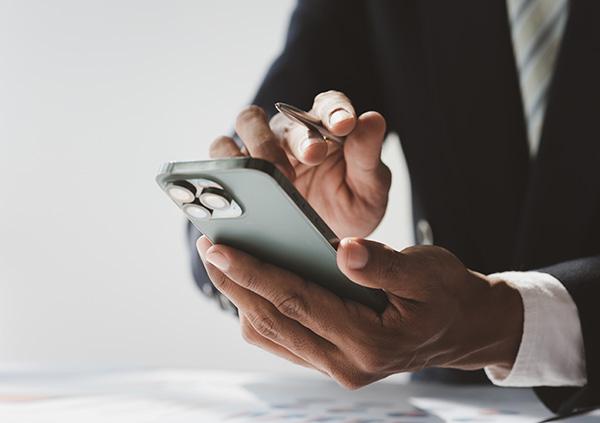 Business man in suit using his cell phone