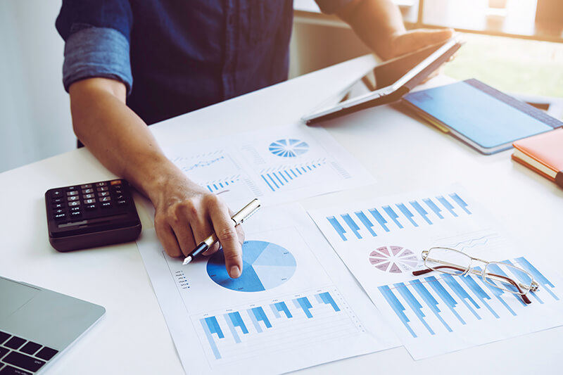 Business person pointing to report on desk