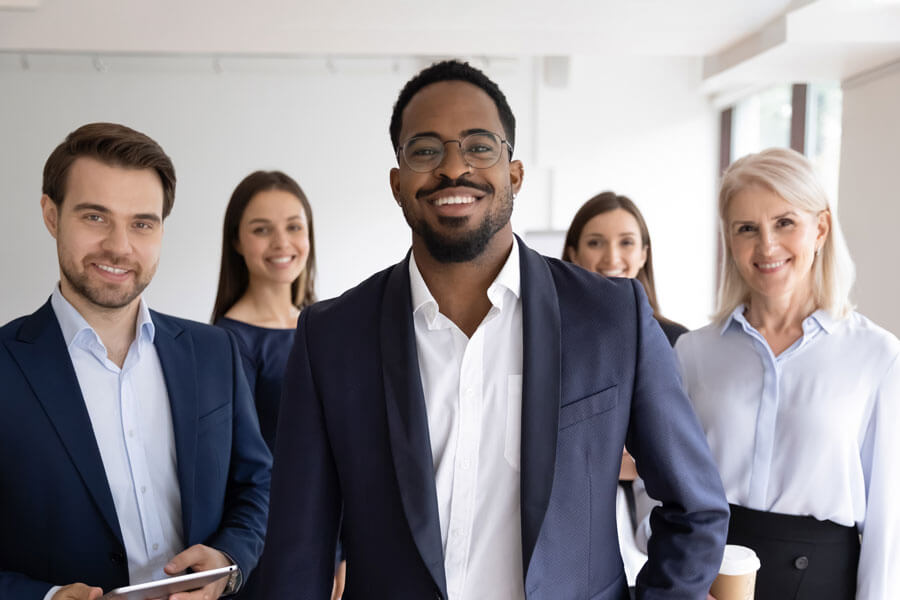 Diverse group of coworkers posing together in office